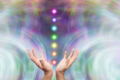 Hands with colored lights and abstract background.